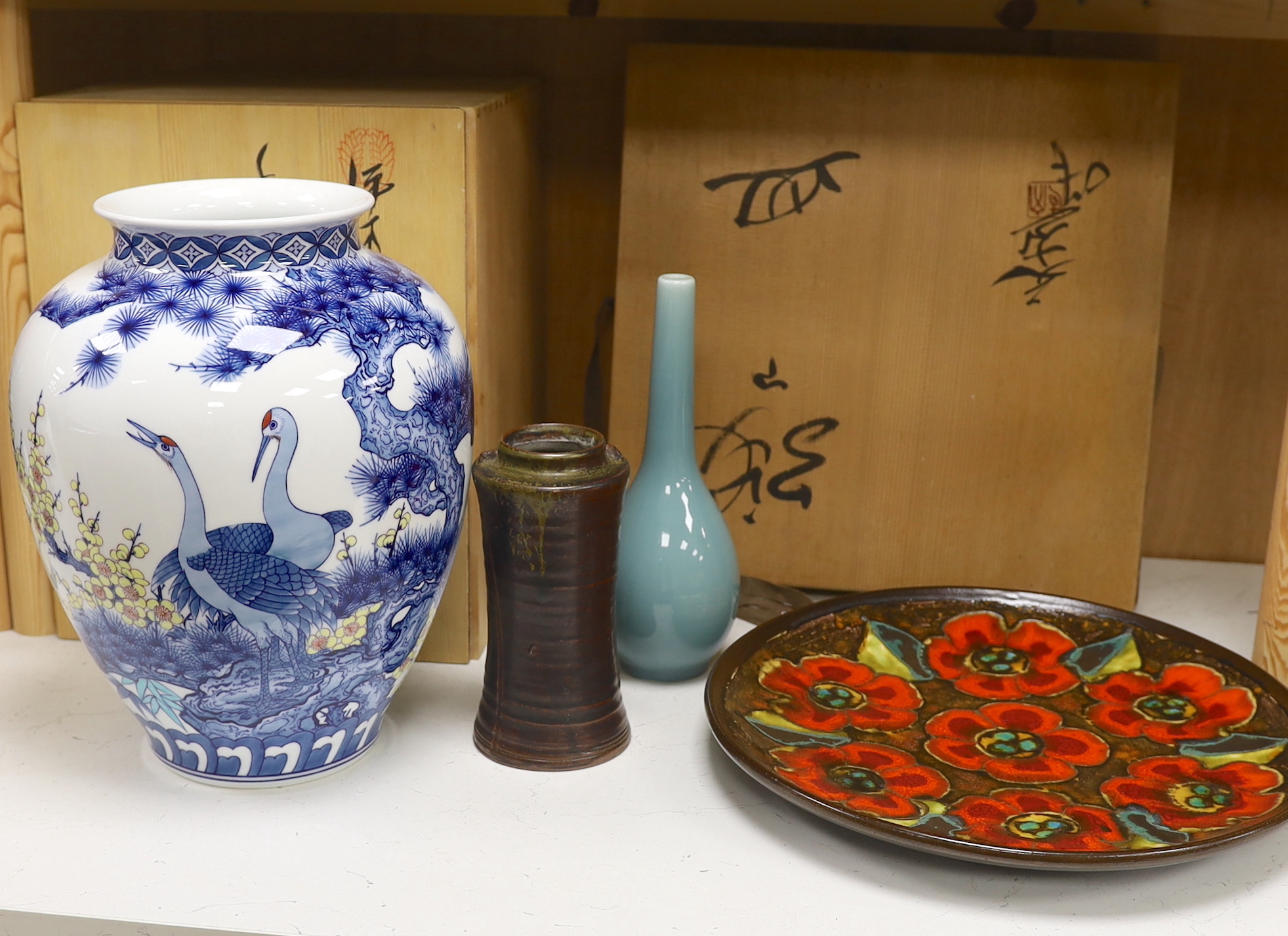 A Japanese blue and white ‘crane’ vase with wooden box, two other Japanese vases and an enamelled dish, also with wooden box. Dish 35cm diameter